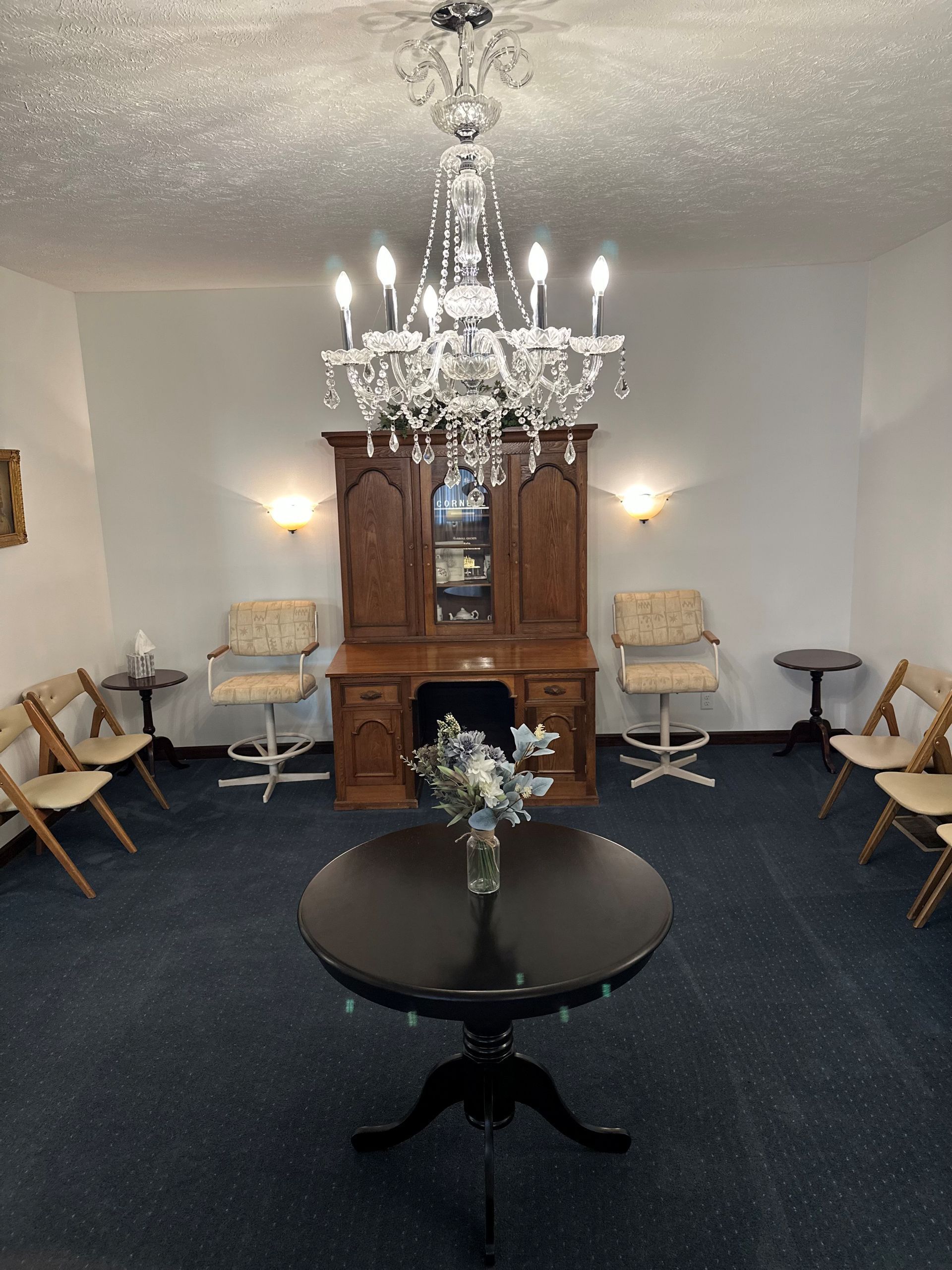A room with a table and chairs and a chandelier