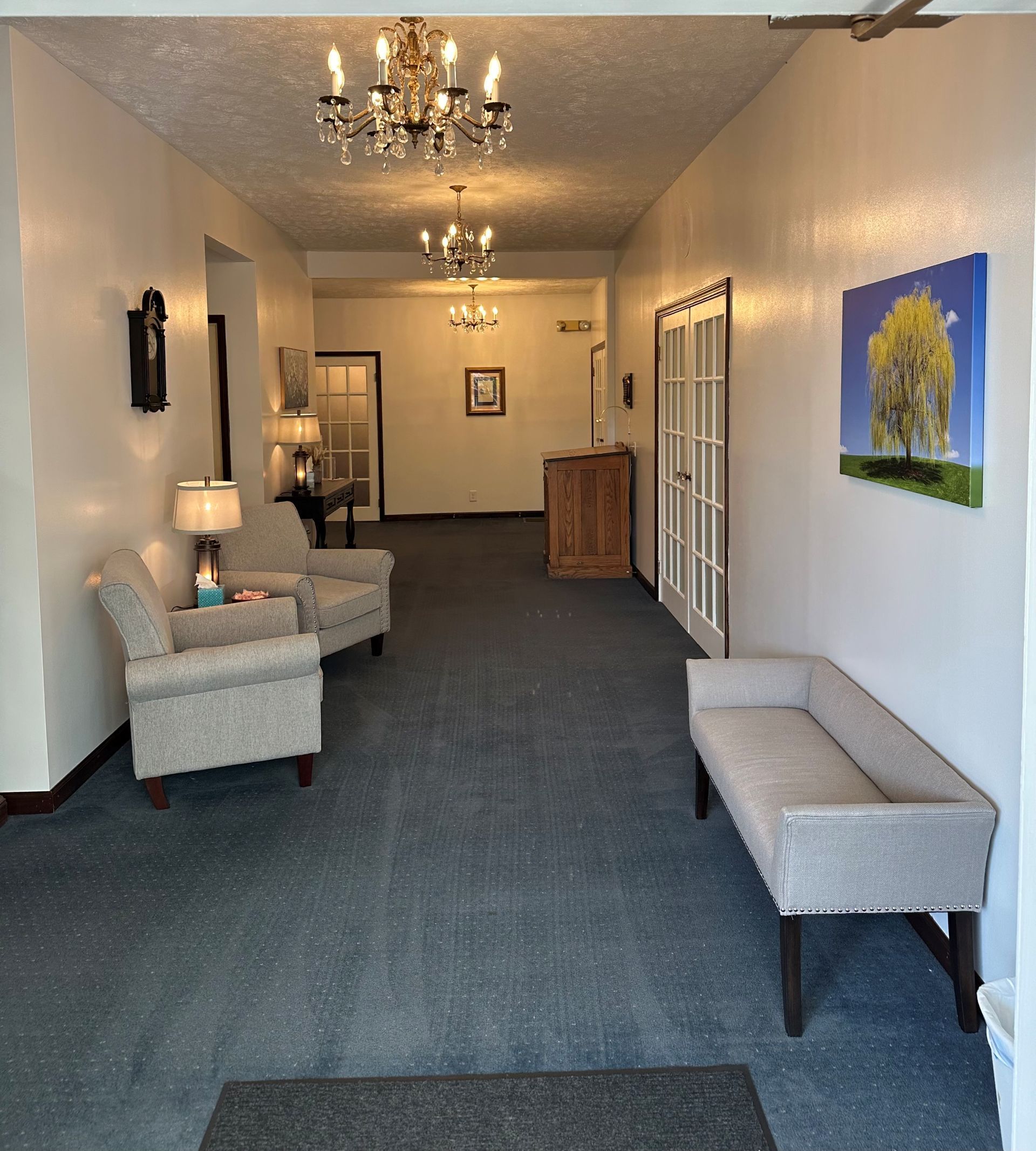 A long hallway with chairs and a bench