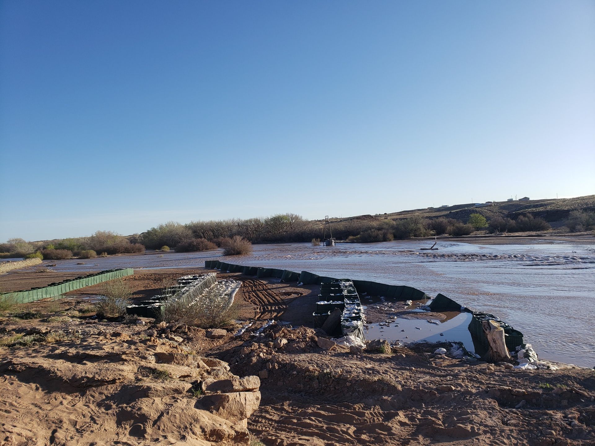Multiple lines of flood barriers were deployed to stop floodwater that was actively flooding the town