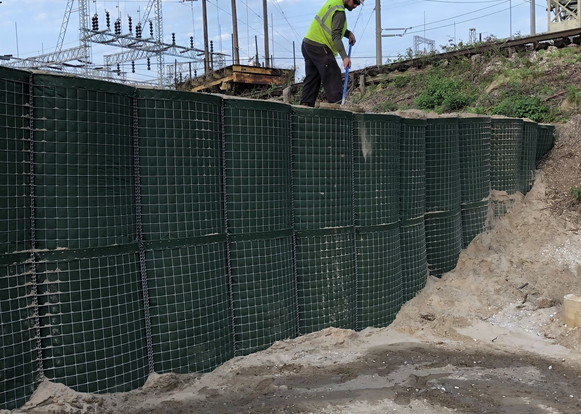 How to tie a HESCO flood barrier into a levee to create a a fully enclosed flood wall