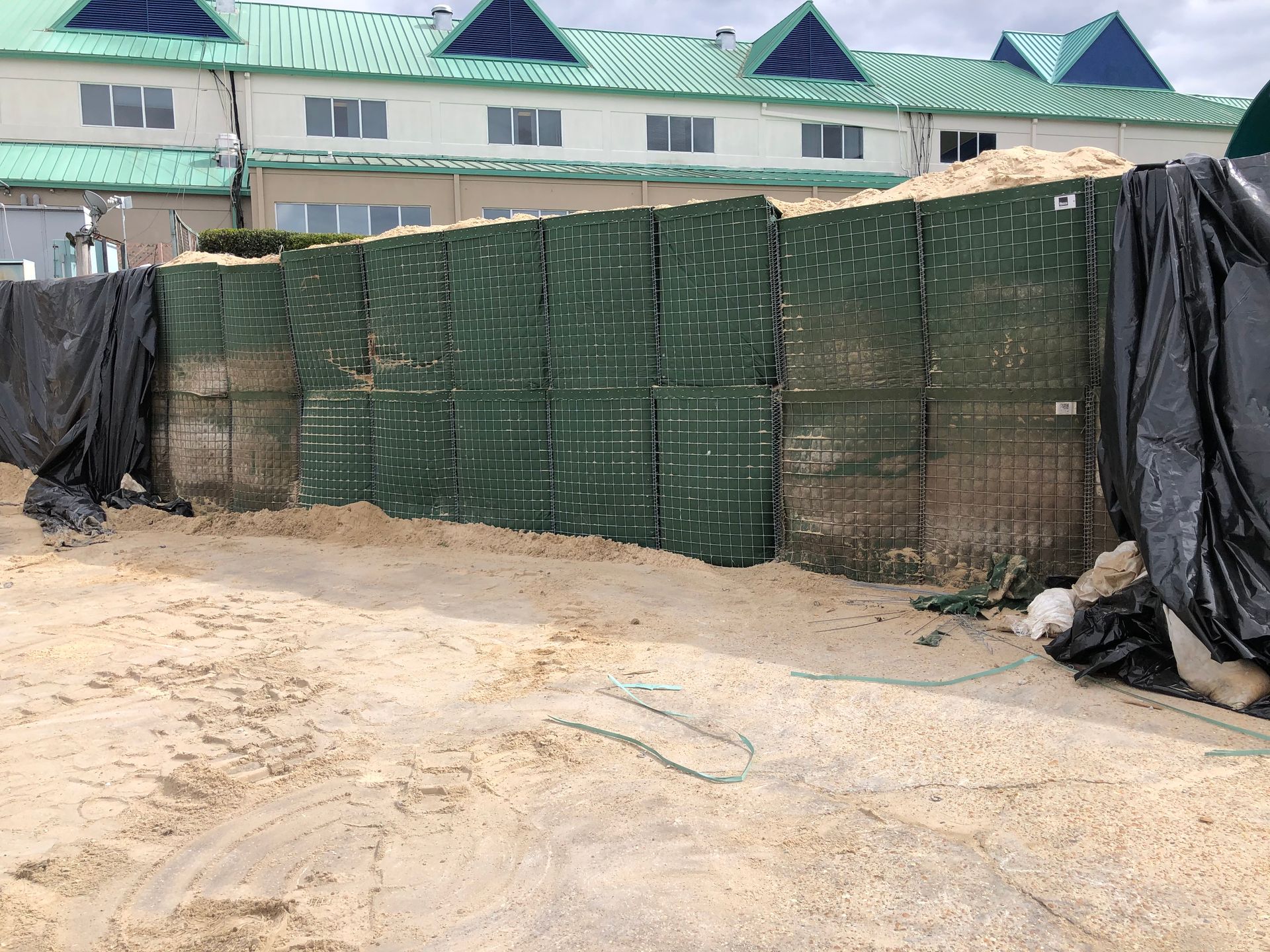 HESCO Bastion Flood Barrier Gap Closure to protect a building from flooding after being closed  