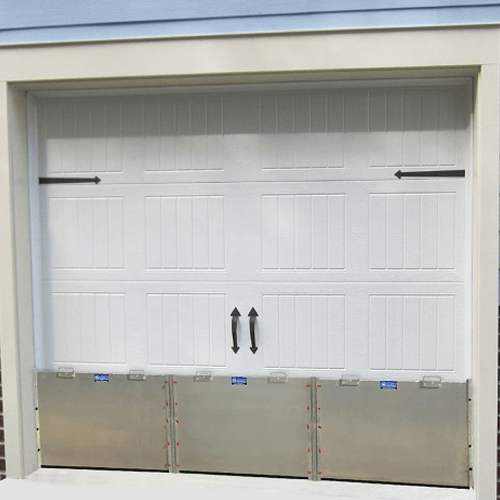 How to protect a garage door from flooding by linking multiple flood panels together using removable upright posts.