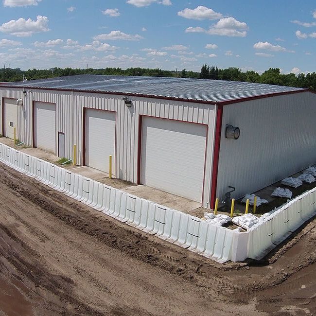 Muscle Wall flood barrier being used to protect a commercial building from flooding.