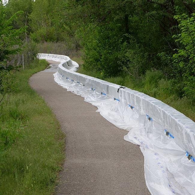 Muscle Wall flood barrier being used to raise a levee in Boise Idaho to stop flooding.