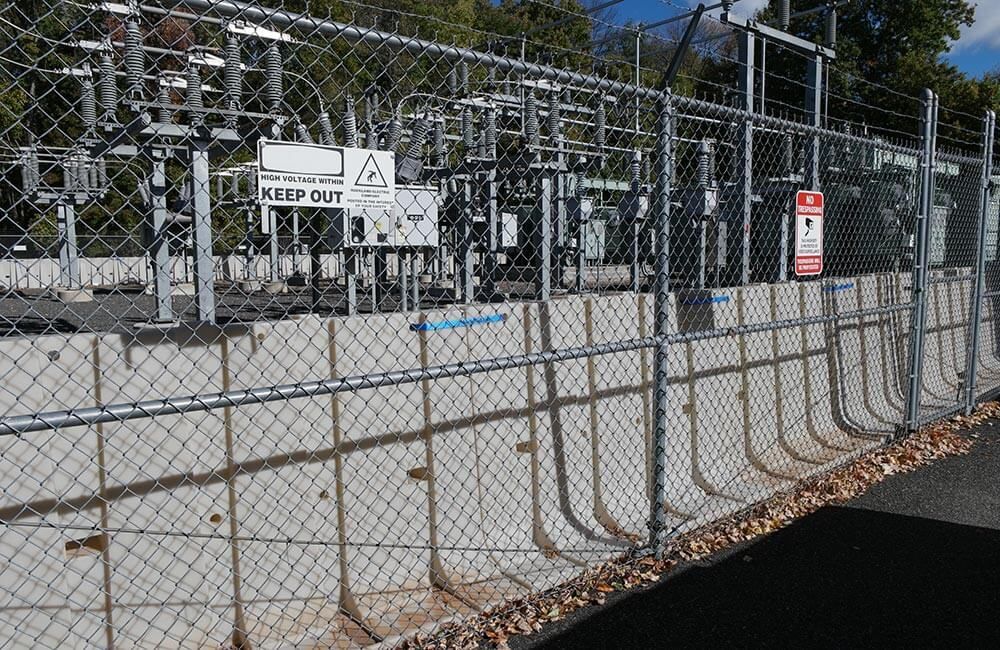 Flood protection for electrical power substation and critical infrastructure using the Muscle Wall flood barrier.