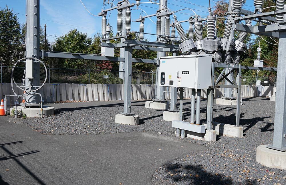 Muscle Wall flood barrier protecting a power substation from rising floodwater.