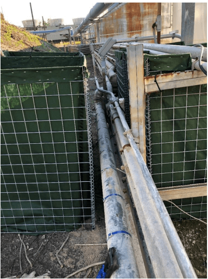 To transition a HESCO Flood Barrier through these pipes and create a seal against floodwater, the barrier needs to be modified. 1st - stretch two HESCO units out on either side of the obstacle 2nd - Cut a wire panel that you can attach to each HESCO from step 1 that also conform around the pipes 3rd - After your connection is made, you can line it with fabric and fill while making sure to safely compact the fill material around the pipes