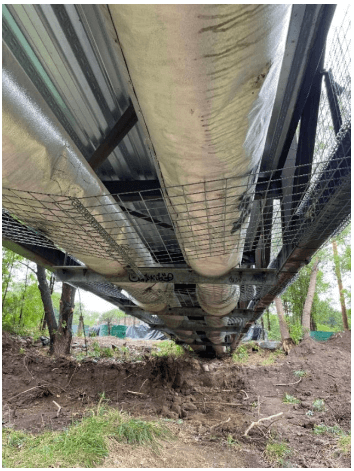 Bridge protection in progress using HESCO flood barrier weldmesh