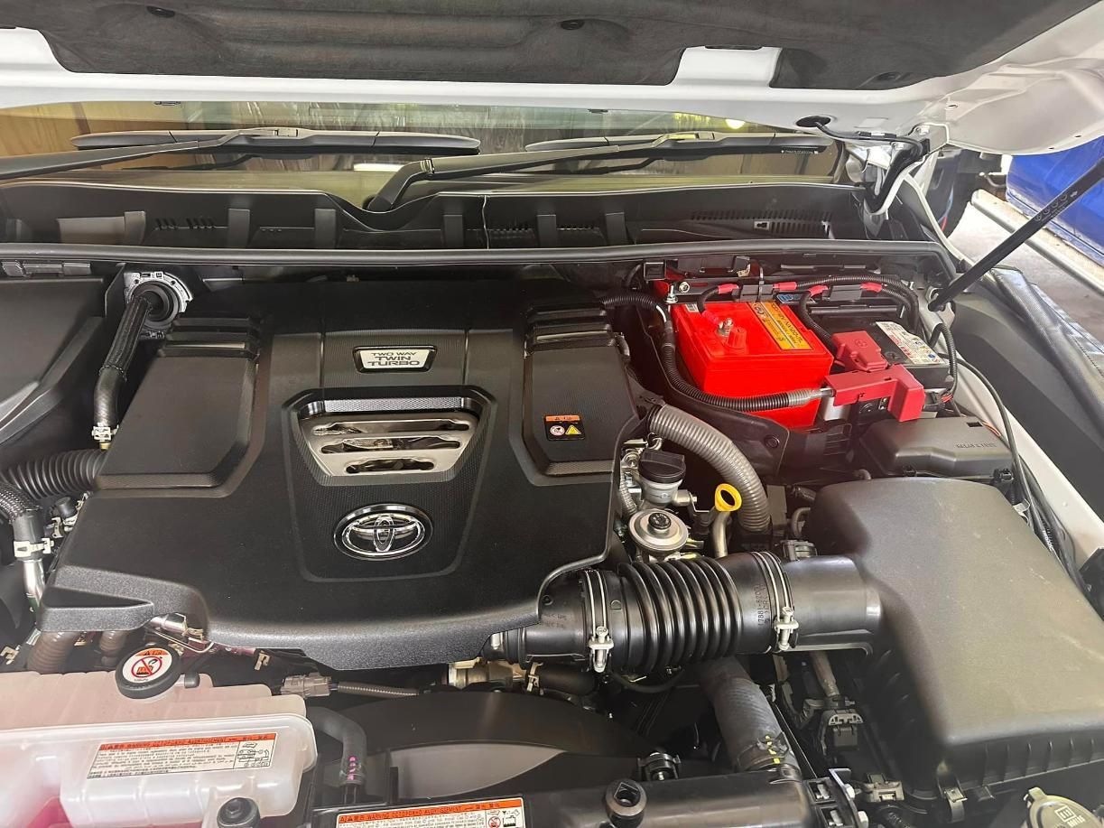 The Engine of a Car With the Hood Open and a Red Battery — Edmonton Battery Centre In Bentley Park, QLD