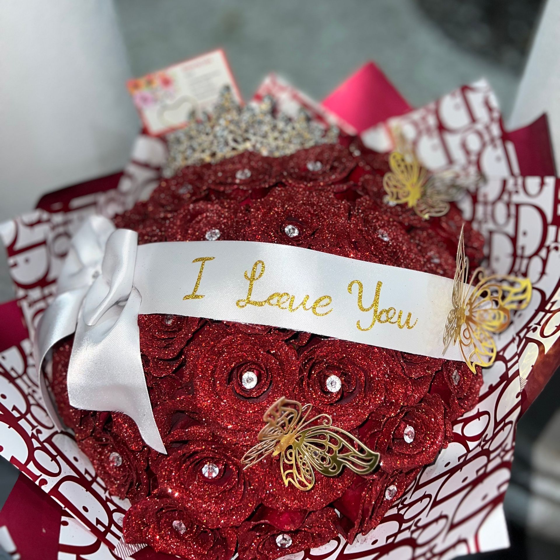 A bouquet of red roses with a ribbon that says i love you