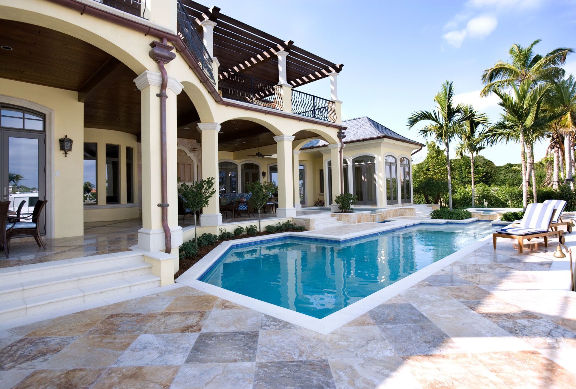 A large house with a large swimming pool in front of it
