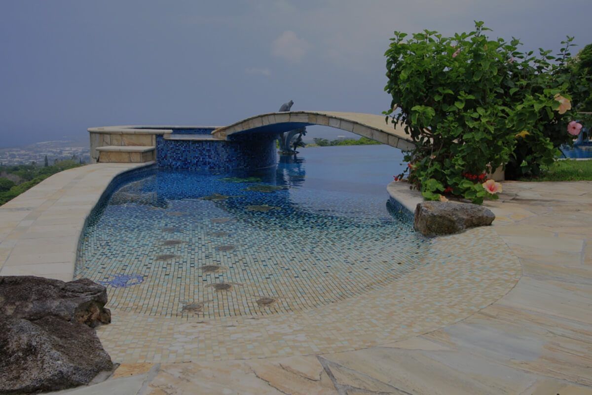 A large swimming pool with a bridge over it