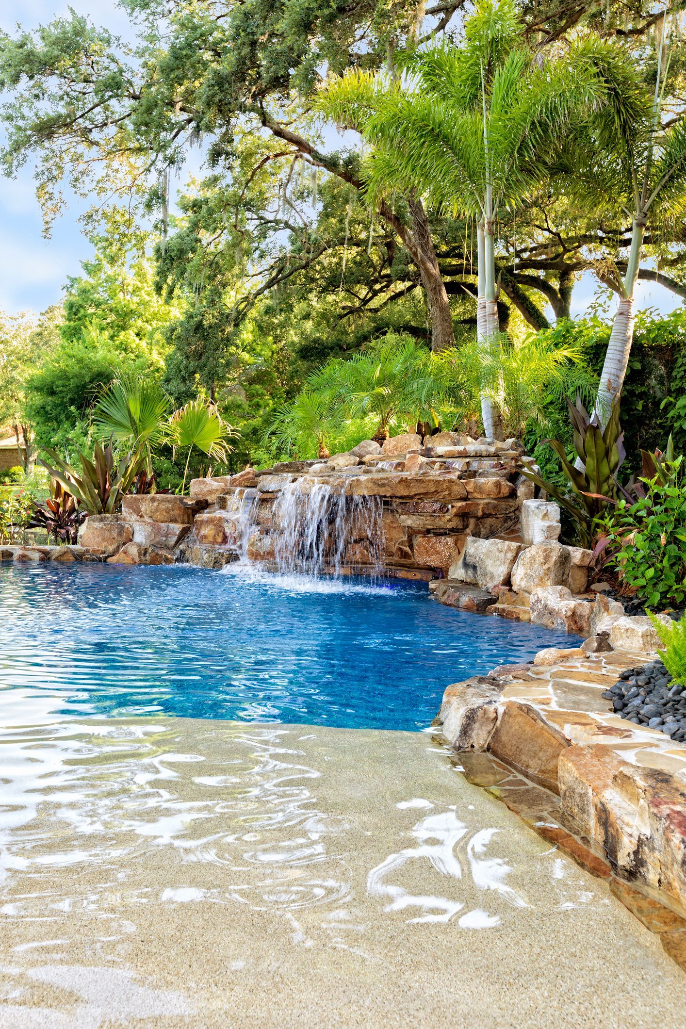 There is a waterfall in the middle of the pool.