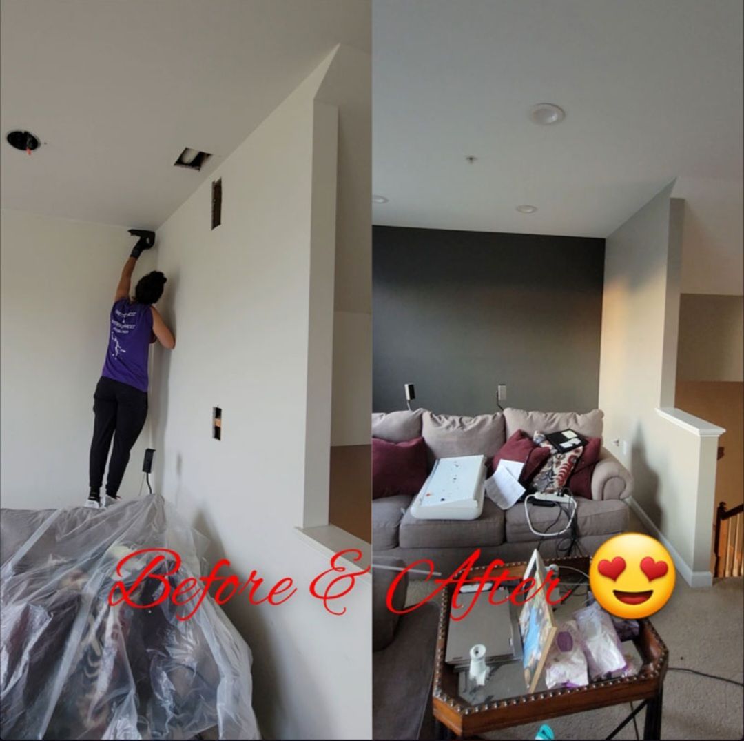 Before and after of a room painting; a person paints a wall, then after with dark gray wall and sofa.