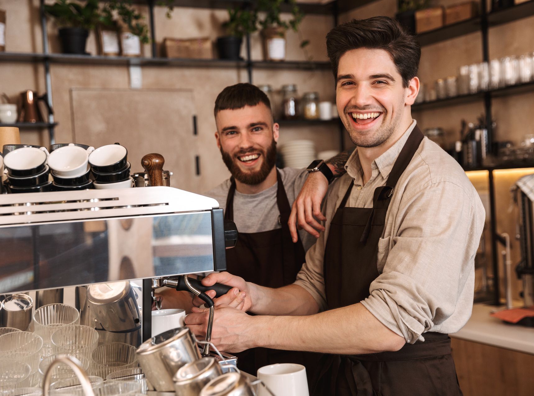 Two baristas working in a coffee shop