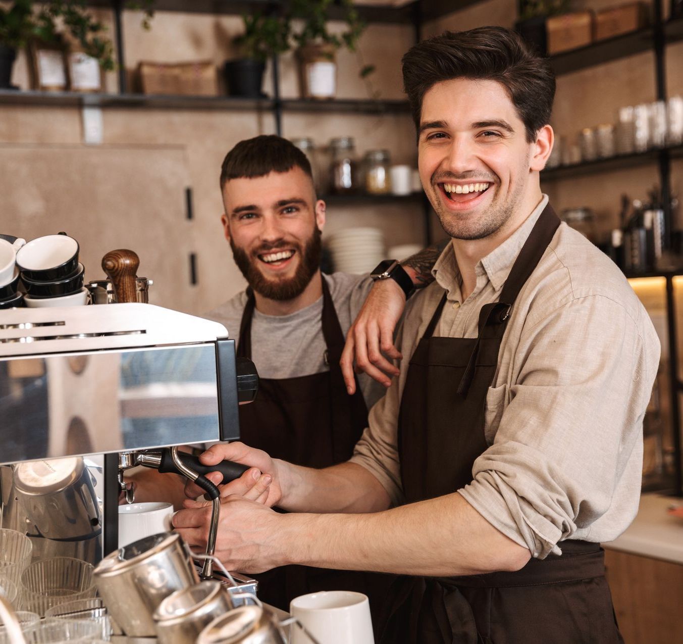 Two baristas working in a coffee shop