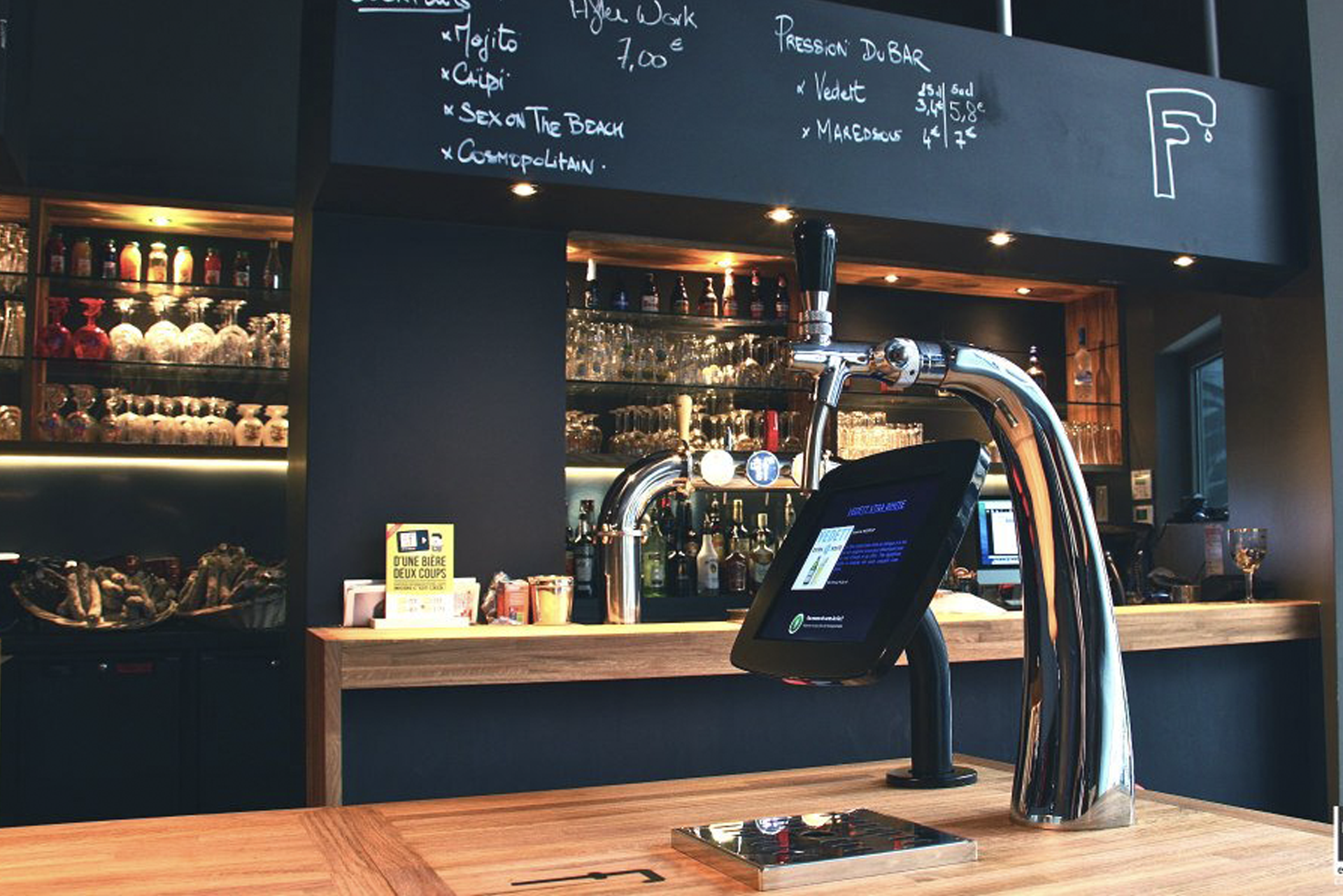 Self-serve beer tap on table in a bar