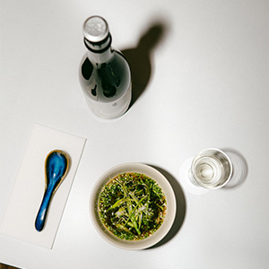 A plate of sliced pork and shredded vegetables on a restaurant table