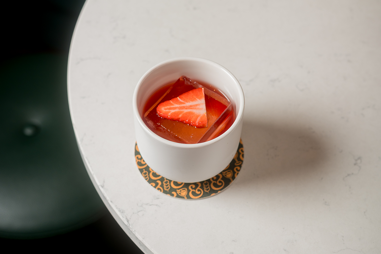 Four people toasting drinks: beer and cocktails