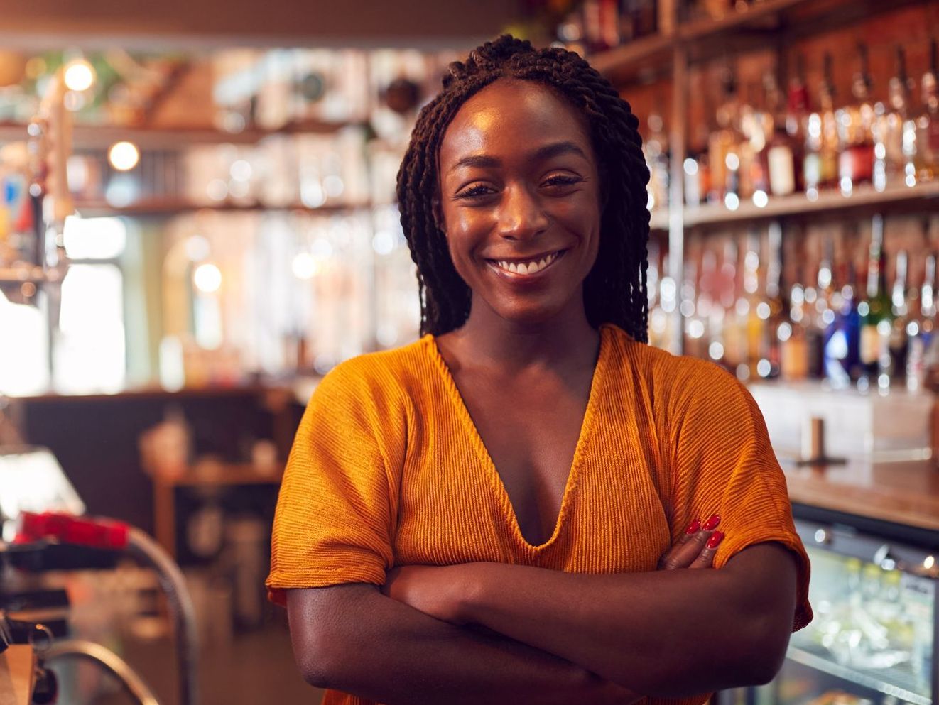 Lady smiling behind a bar