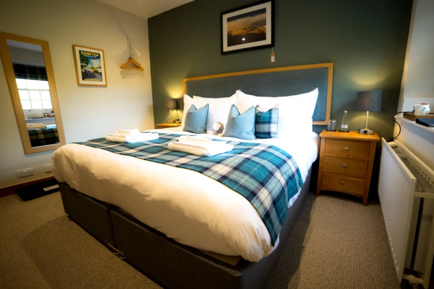 A nicely decorated hotel room with a king size bed