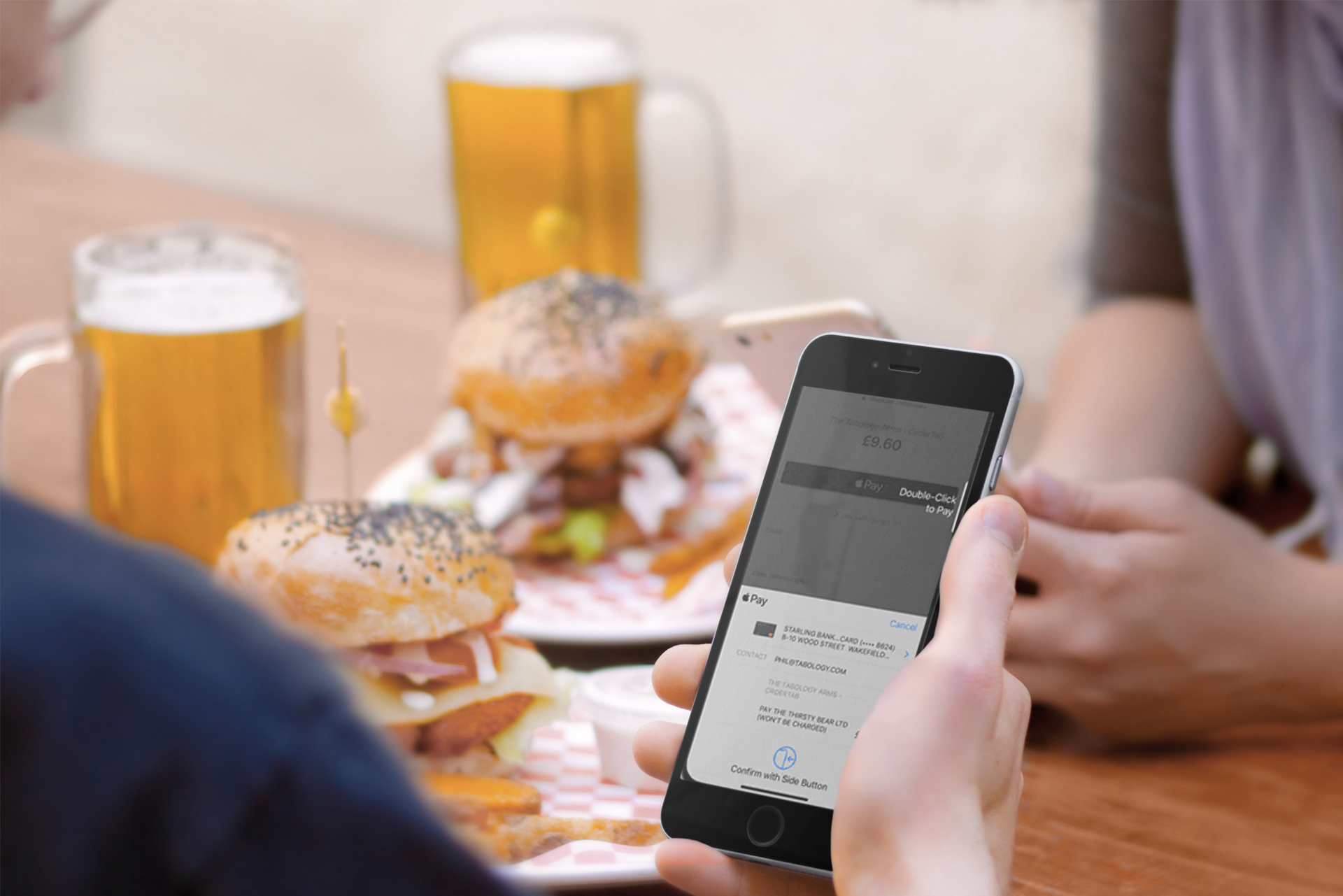 Mobile ordering in a pub, paying with Apple Pay