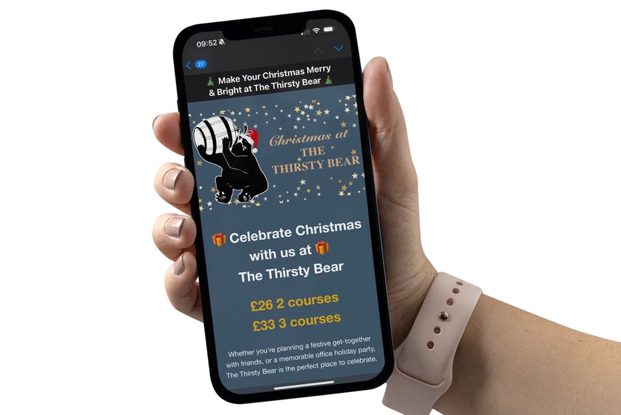 a hand holding a phone displaying a Christmas meal offer at The Thirsty Bear pub