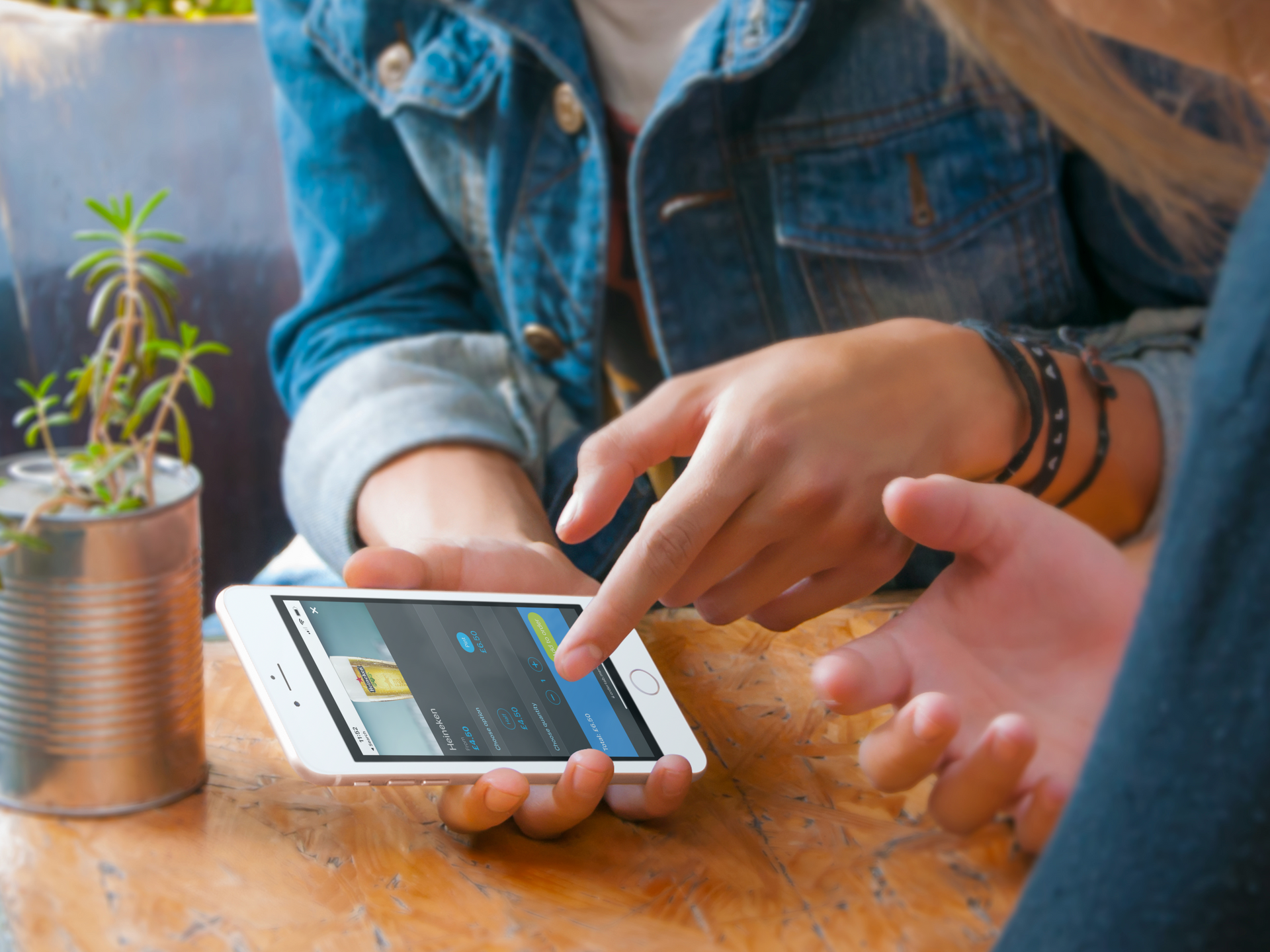 An iphone which two female friends are using to order a beer online