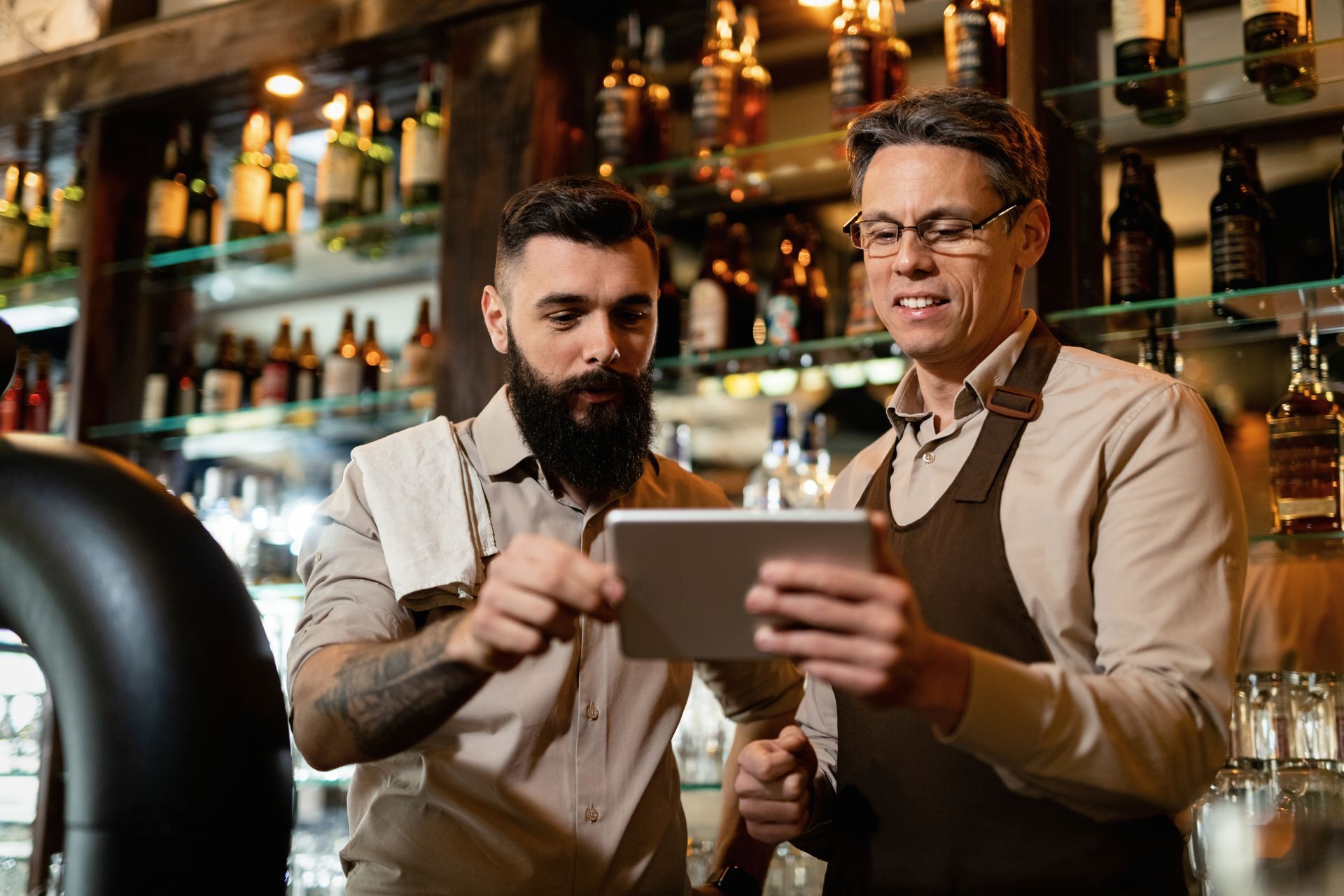 Two bartenders using an iPad-based EPOS