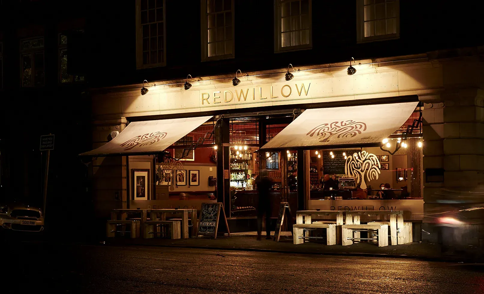 The outside of RedWillow's bar, lit up at night