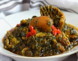 A close up of a bowl of food on a table.