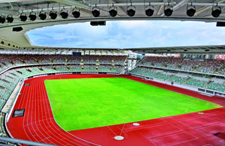 An empty stadium with a track in the middle of it.