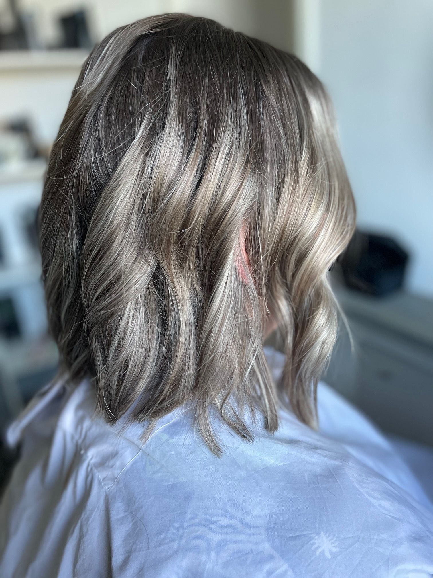 Bobkapsel tot op de schouders met golvend lichtbruin haar.