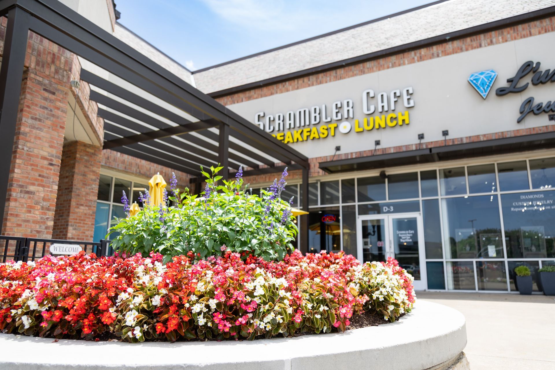 A restaurant with a lot of flowers in front of it