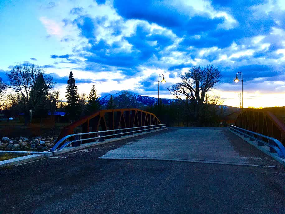 A bridge over a river with a blue sky in the background