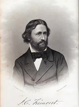 A black and white photo of a man in a suit and bow tie.