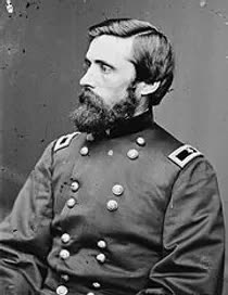 A black and white photo of a man in a military uniform with a beard.