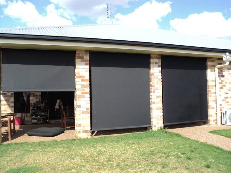 Black Outdoor Roller Blinds Covering Windows — Toowoomba Shade & Canvas in Harristown, QLD