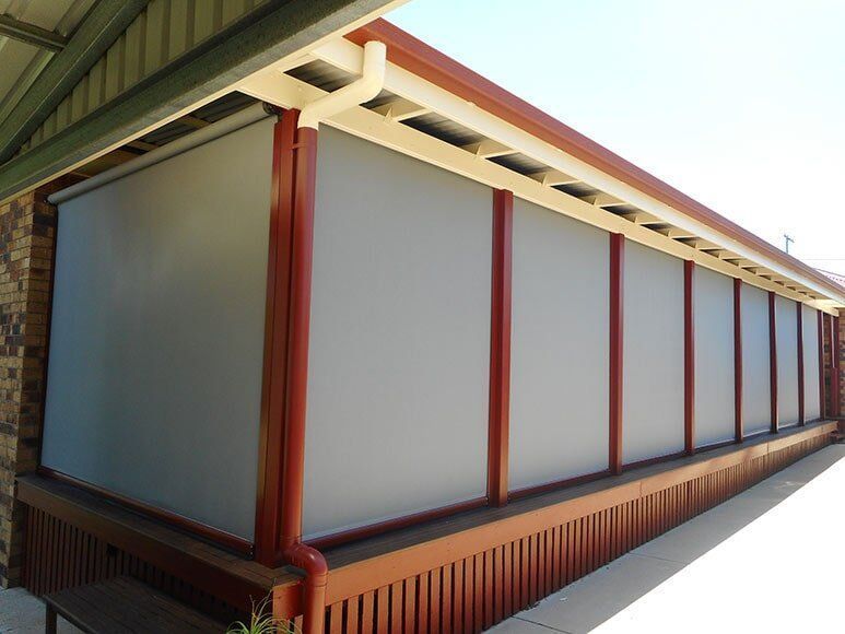 Outdoor Patio With Several Closed Gray Roll-down Blinds — Toowoomba Shade & Canvas in Harristown, QLD