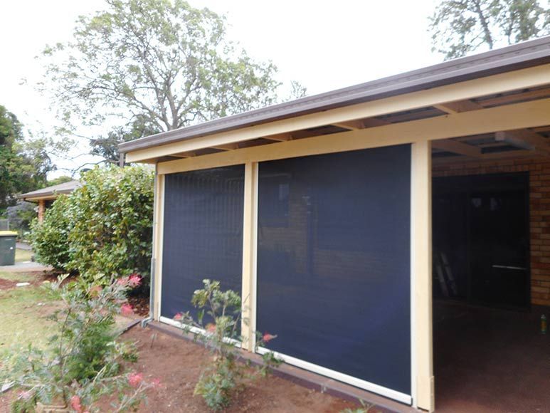 Dark Screens on a Carport With Tan Trim and a Brown Roof — Toowoomba Shade & Canvas in Harristown, QLD