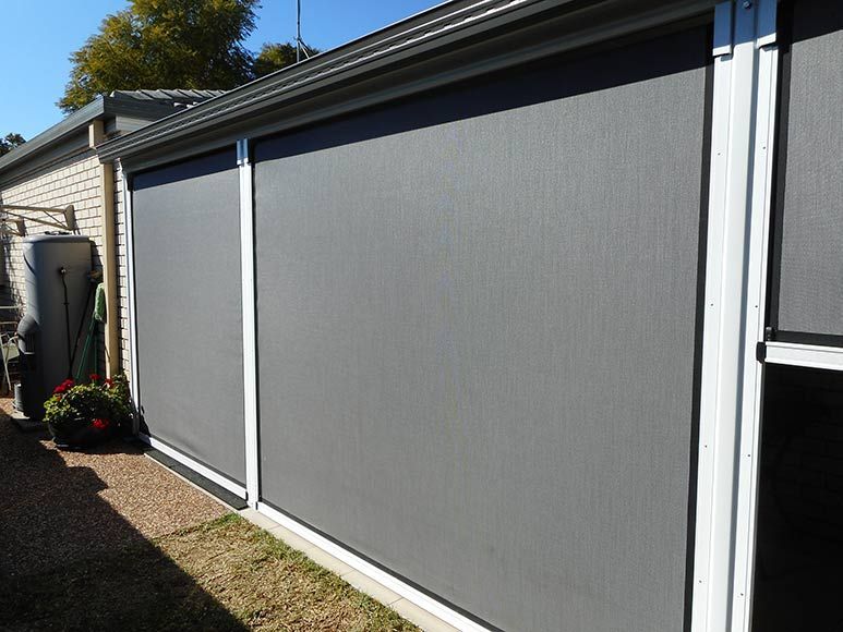 Grey Outdoor Blinds Installed on a Brick Building — Toowoomba Shade & Canvas in Harristown, QLD