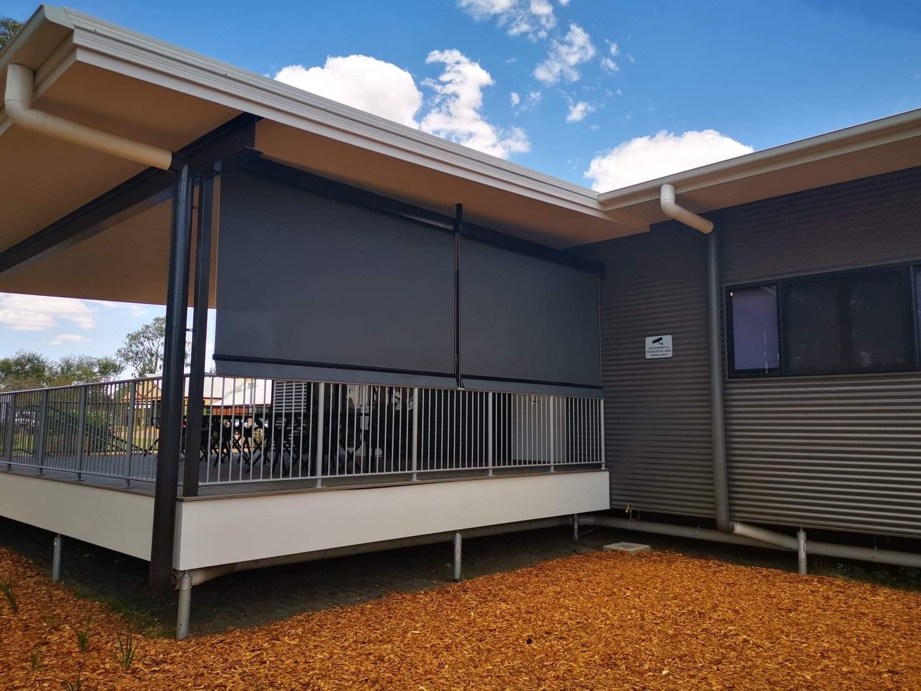 Dark Gray Outdoor Shade on a Patio, Attached to a Brown Building — Toowoomba Shade & Canvas in Gatton, QLD