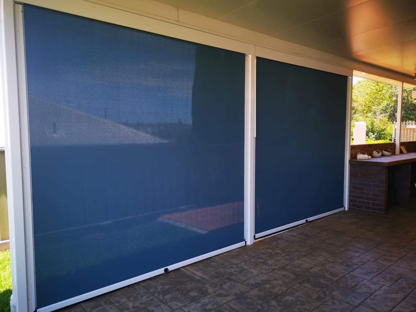 Two Dark Blue Outdoor Roller Shades Installed on a Patio — Toowoomba Shade & Canvas in Harristown, QLD