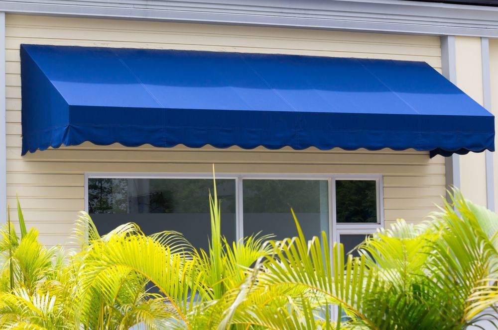 Blue Awning Over a Window on a Beige Building — Toowoomba Shade & Canvas in Gatton, QLD