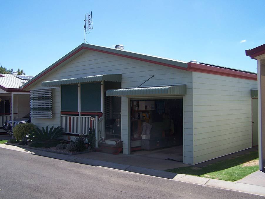 Light Yellow One-story House With Garage and Awning Under a Blue Sky ā Toowoomba Shade & Canvas in Harristown, QLD