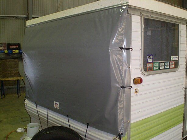 Grey Awning Covering the Back Side of a White and Green Campervan — Toowoomba Shade & Canvas in Harristown, QLD