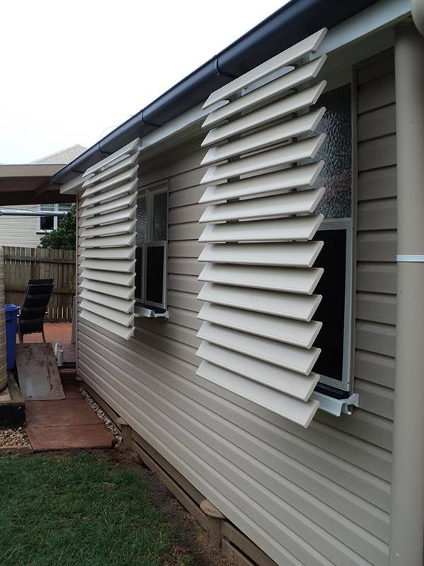 Exterior View of a House With Open, White Louvered Shutters — Toowoomba Shade & Canvas in Harristown, QLD