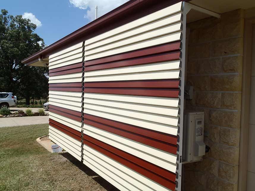 Exterior Wall With Alternating Cream and Burgundy Horizontal Slats — Toowoomba Shade & Canvas in Harristown, QLD