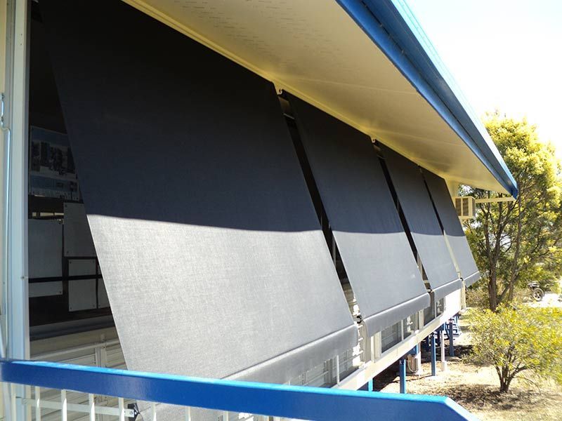 Black Sunshades Partially Lowered on a Building's Balcony ā Toowoomba Shade & Canvas in Harristown, QLD