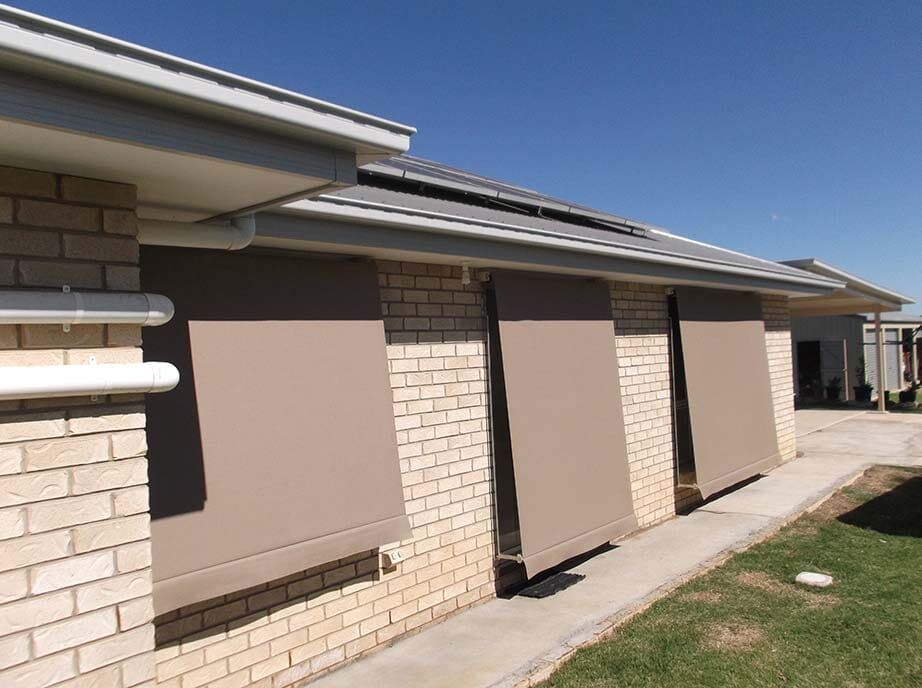 Tan Awnings Covering Windows on a Brick House, Sunny Day ā Toowoomba Shade & Canvas in Harristown, QLD